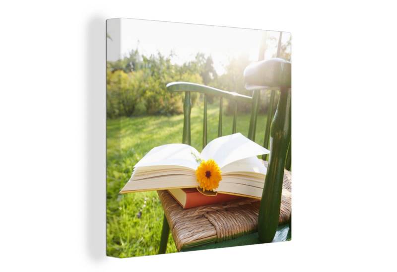 OneMillionCanvasses® Leinwandbild Stuhl mit Buch im Garten, (1 St), Wandbild, Deko Schlafzimmer Wohnzimmer Flur 20x20 cm von OneMillionCanvasses®