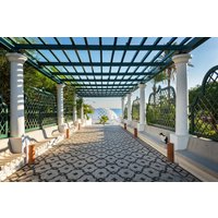 Papermoon Fototapete "PERGOLA-RHODOS BLUMEN SEE MEER TERRASSE PALMEN DÜNEN" von Papermoon