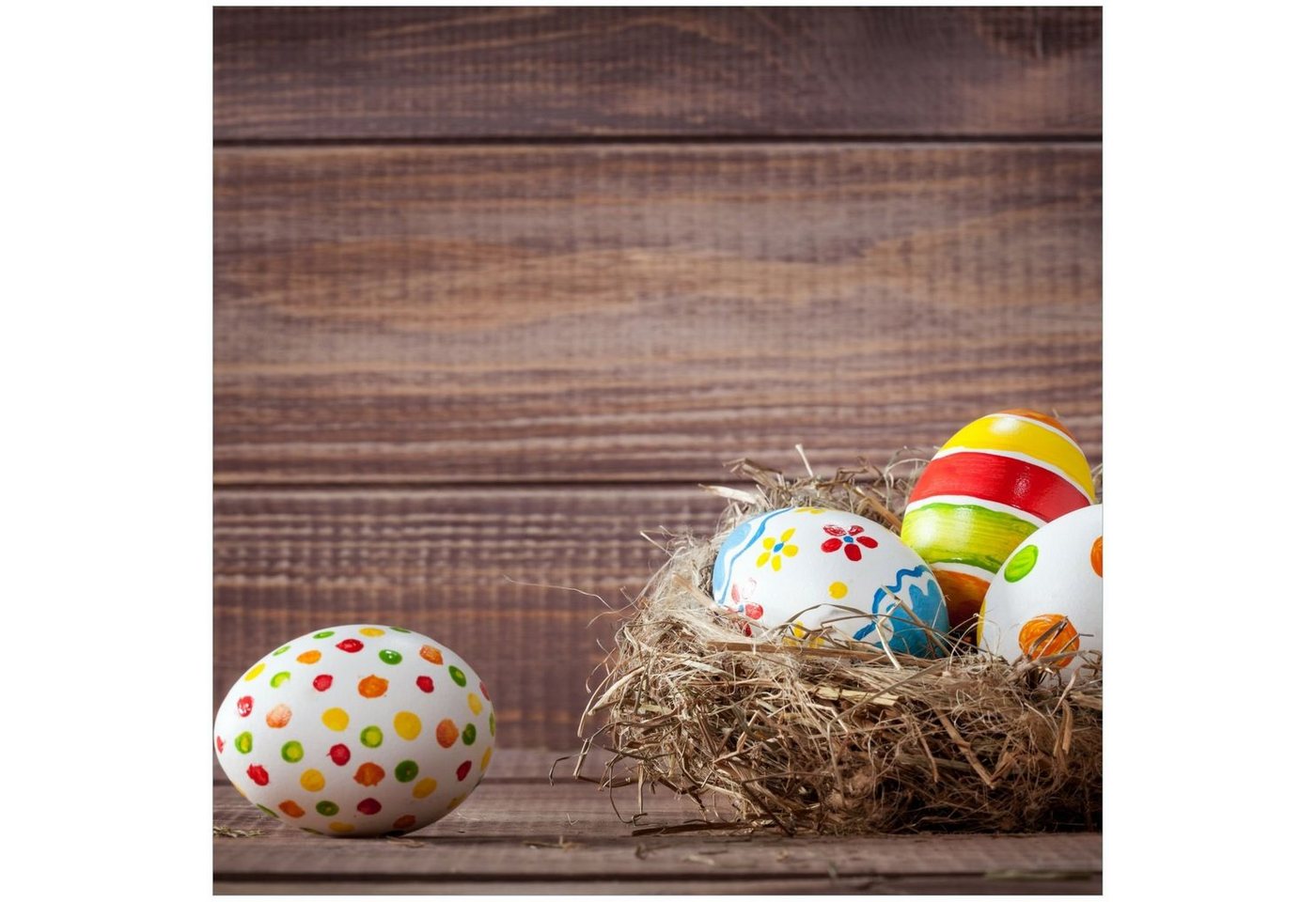 Wallario Acrylglasbild, Bunte bemalte Eier an Ostern im Vorgelnest vor hölzerner Wand, in verschiedenen Ausführungen von Wallario