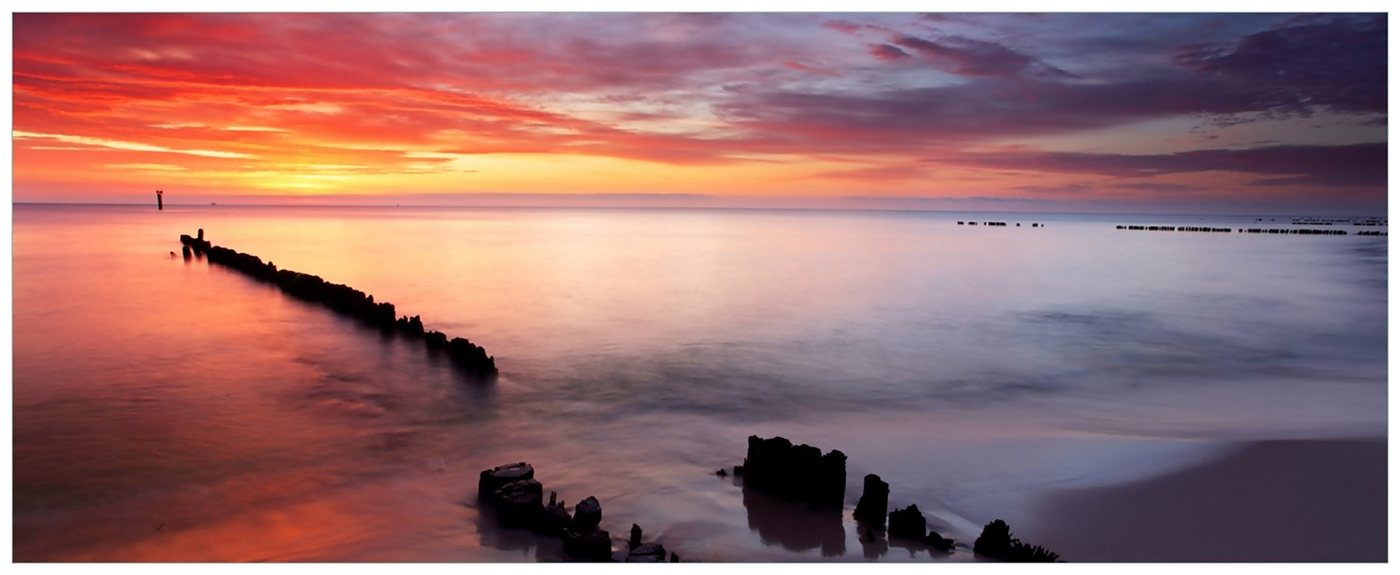 Wallario Acrylglasbild, Sandstrand im Sonnenuntergang - Roter Himmel, in verschiedenen Ausführungen von Wallario