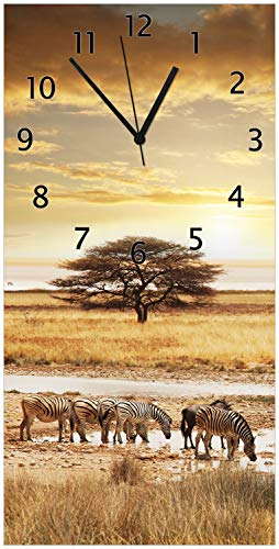 Wallario Design-Wanduhr, Acrylglasuhr Größe 30 x 60 cm, Schwarze Zeiger, Motiv Safari in Afrika eine Herde Zebras am Wasser von Wallario
