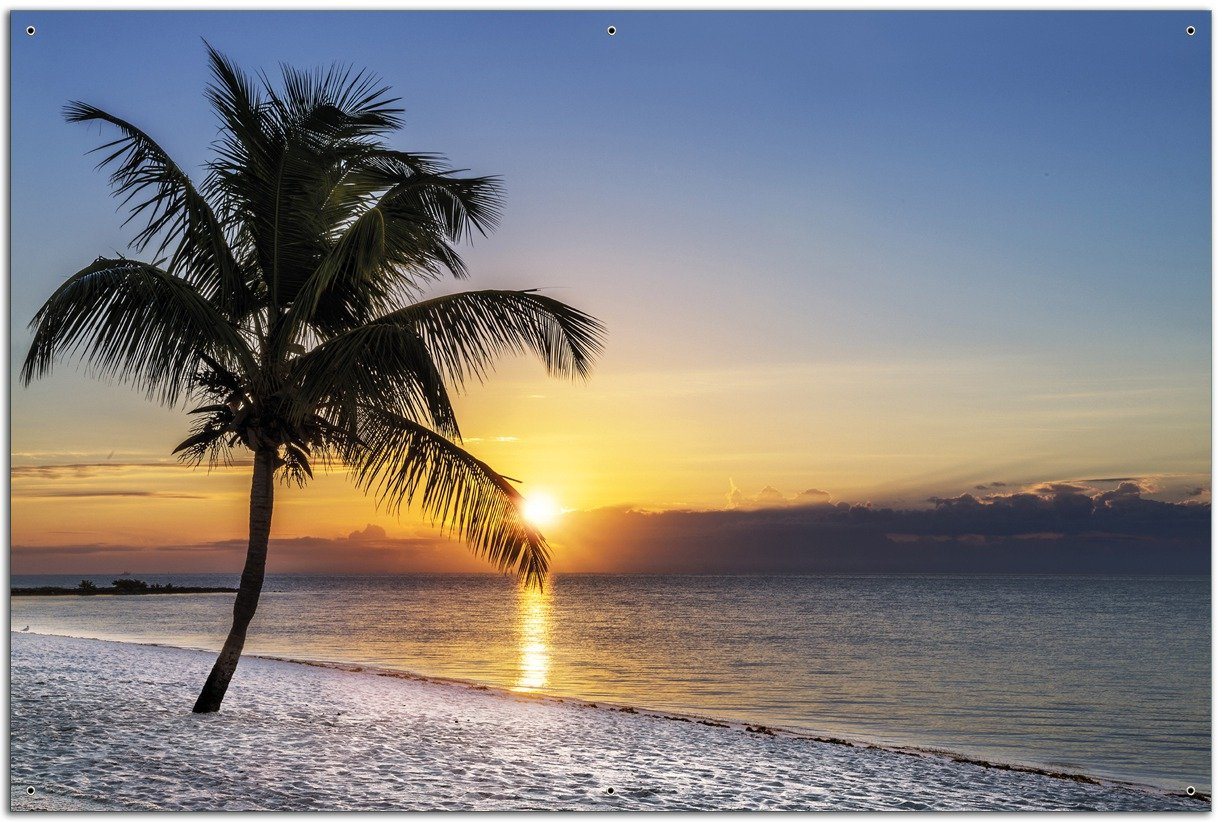 Wallario Sichtschutzzaunmatten Palme am Strand - Sonnenuntergang über dem Meer von Wallario