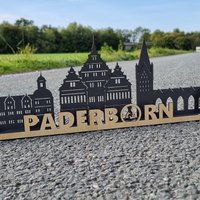 Skyline Der Stadt Paderborn Mit Drei Hasenfenster, Rathaus, Dom Und Schloß Auf Holz von laserundmehrdeko